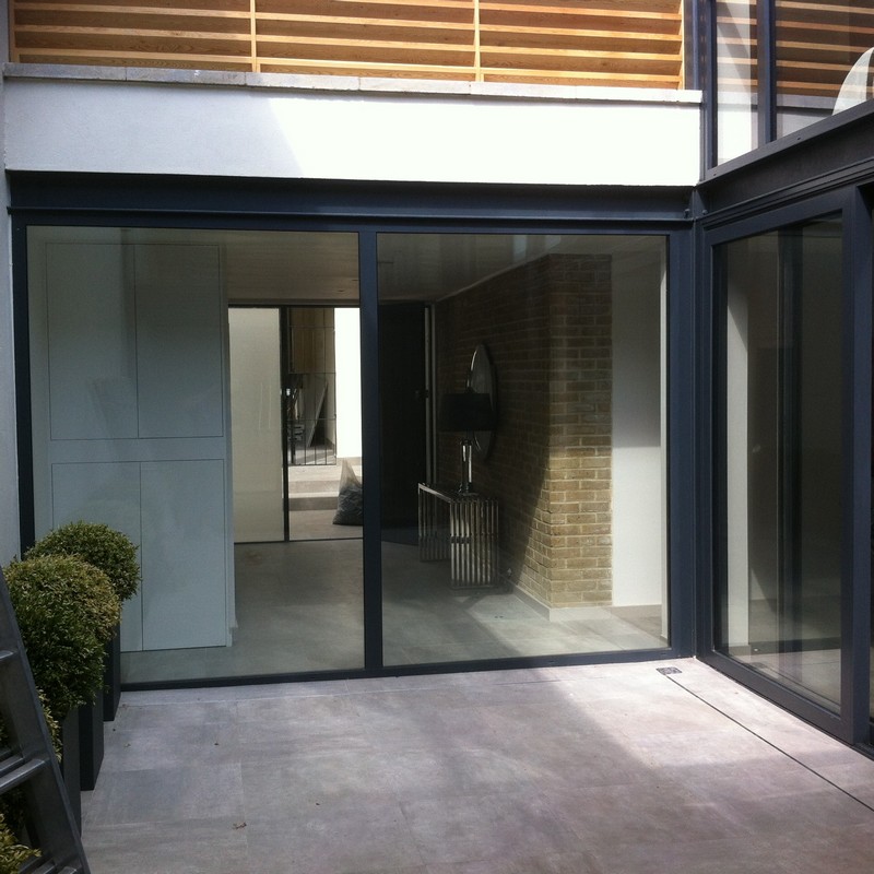 Floor-to-ceiling sliding doors opening to courtyard in Mitcham