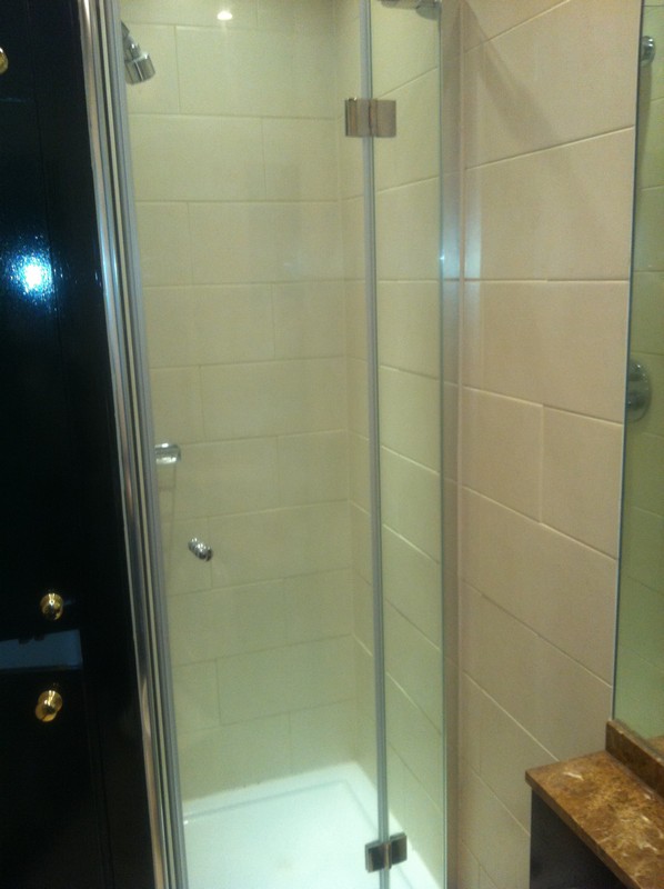 Frameless glass shower enclosure with chrome fittings in Mitcham