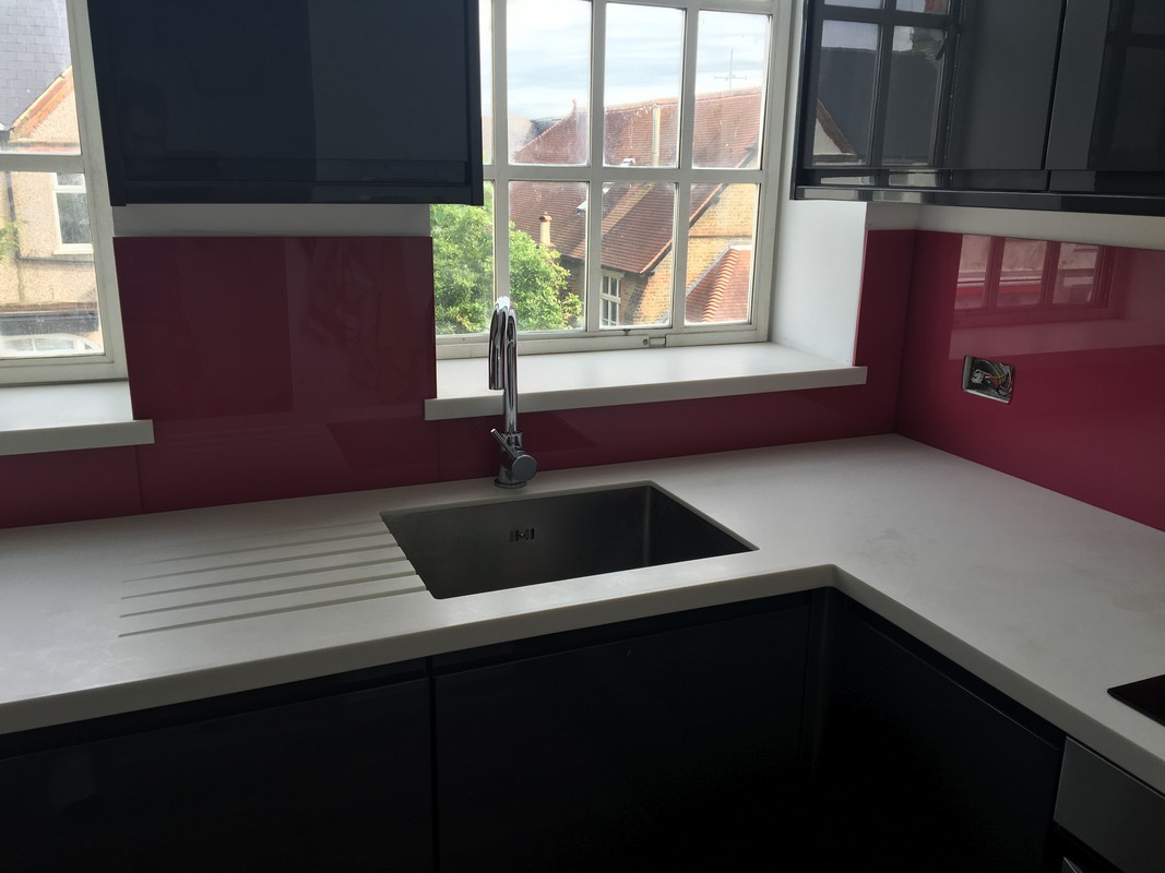 Deep plum coloured glass splashback in modern Mitcham kitchen